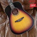 Acoustic guitar with sunburst finish on a brown leather surface, featuring a free shipping label.