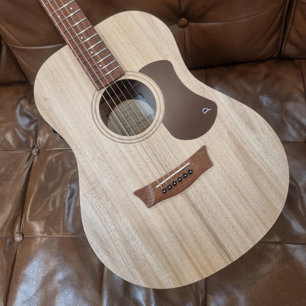 Acoustic guitar on a brown leather couch